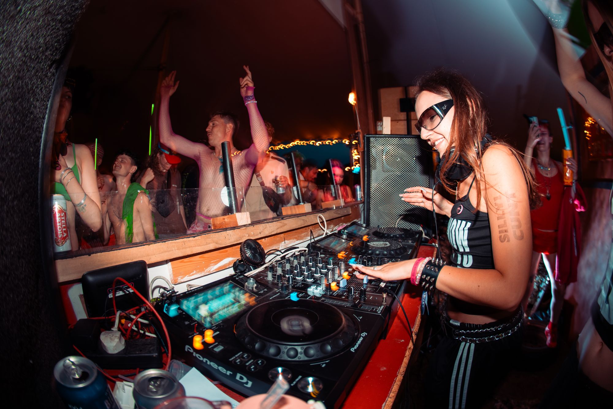 DJ playing to a packed tent at night
