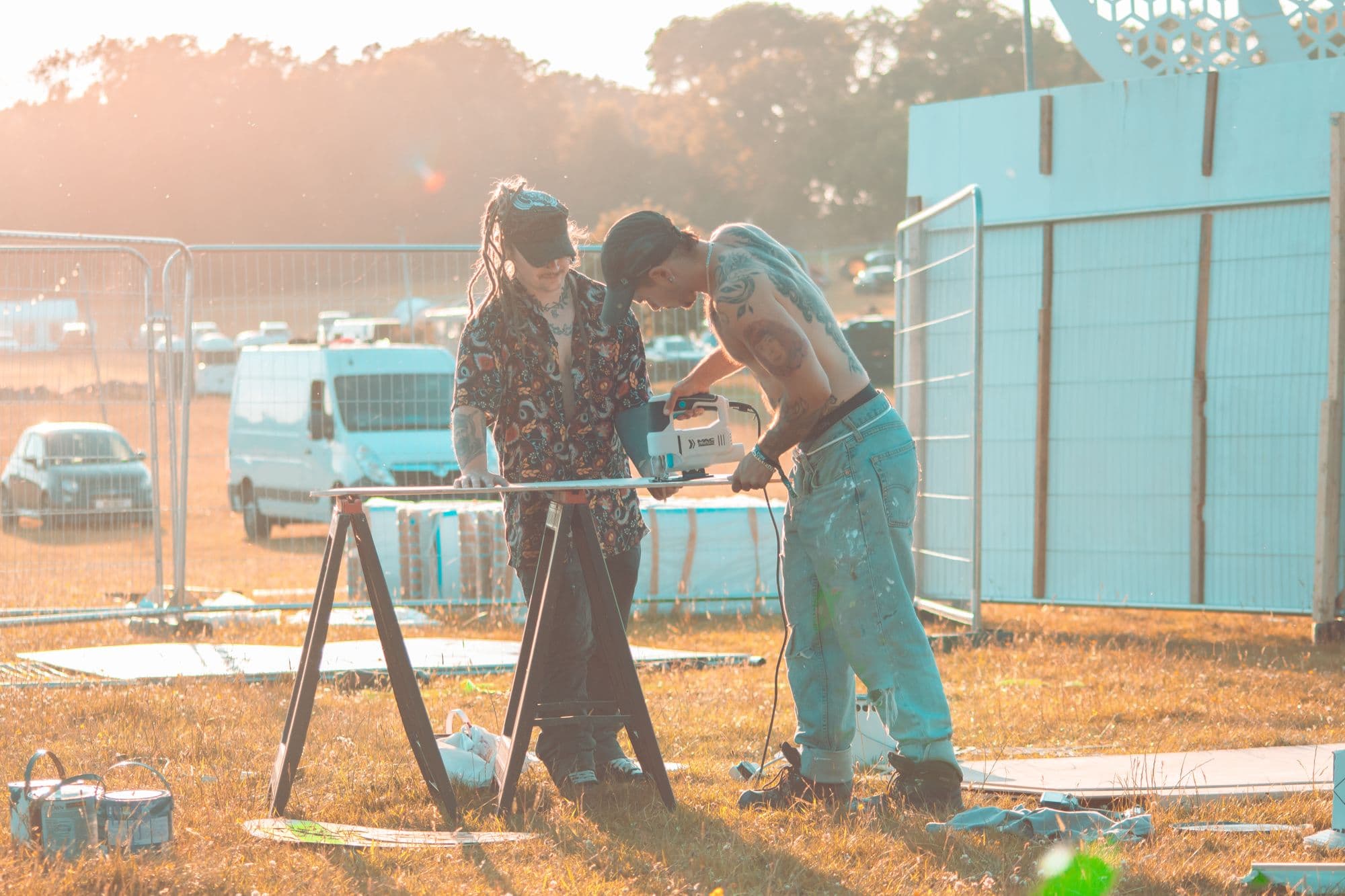 Two crew members building a structure in the field